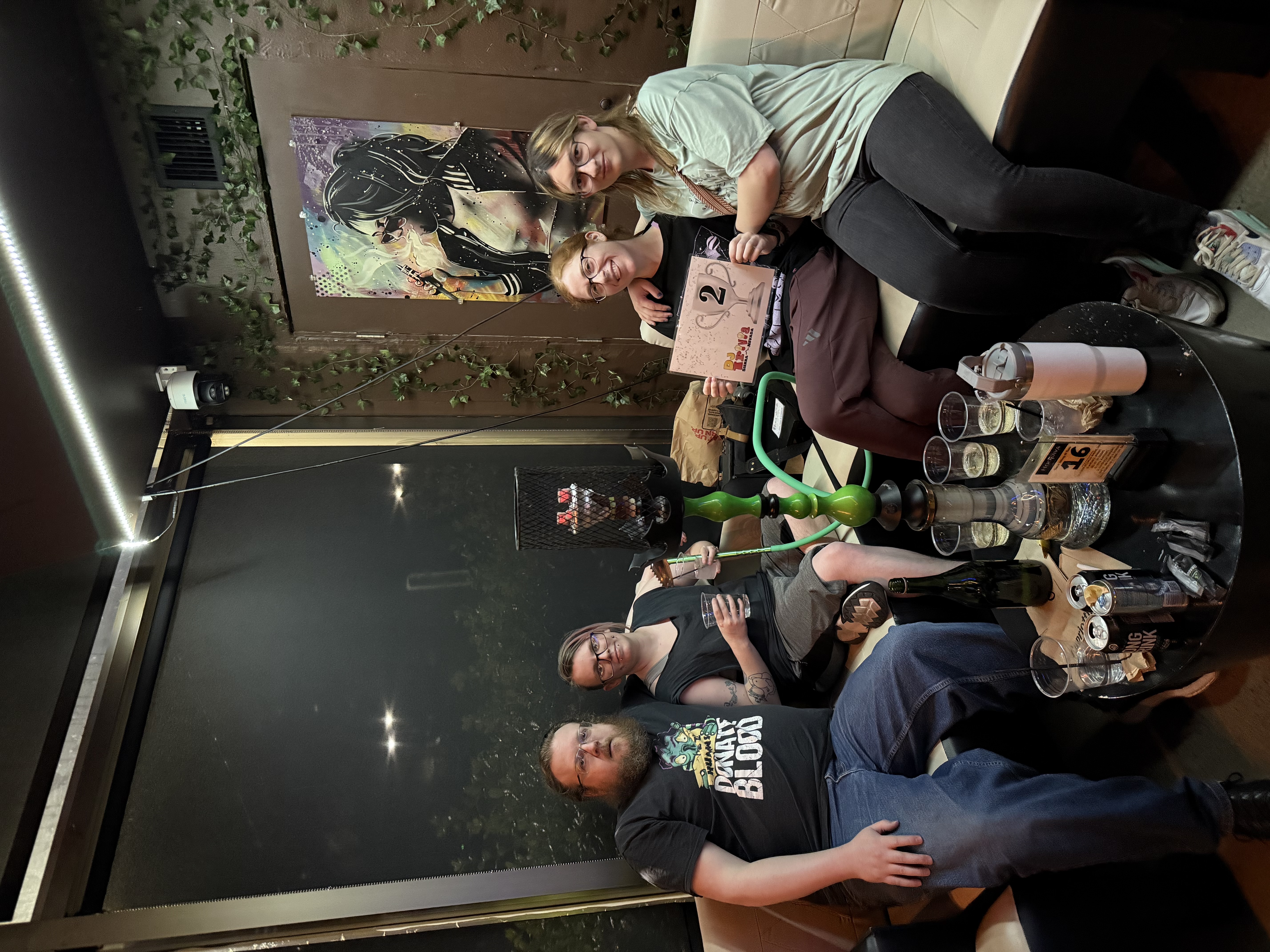 Trivia team celebrating 2nd place at Hookava with hookah on the table