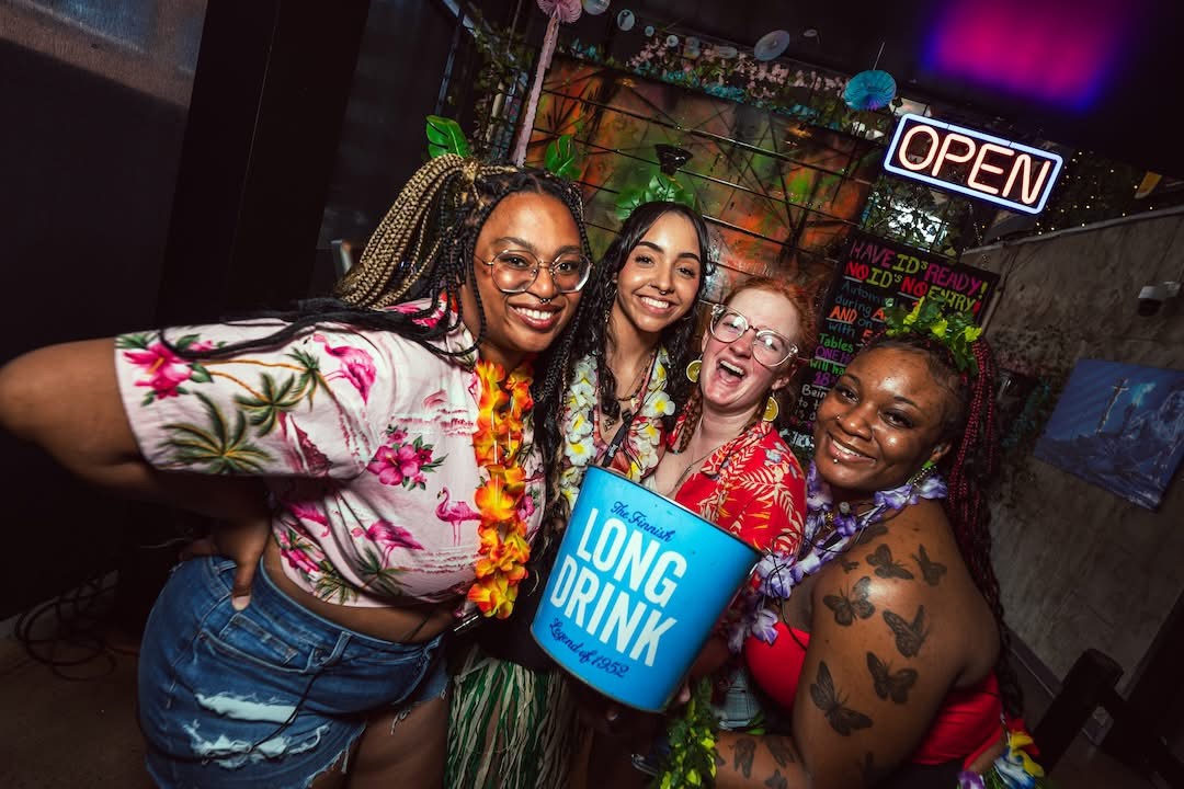 Hookava staff and guests in tropical gear celebrating a Crawl Reno event