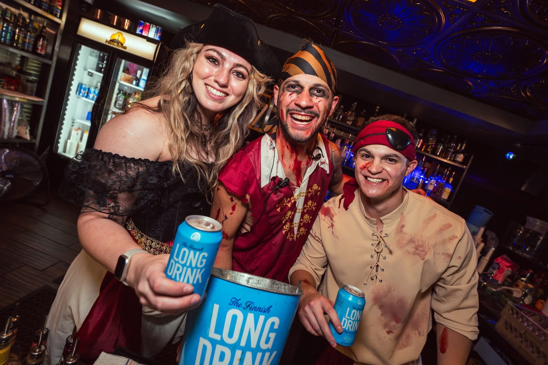 Guests in zombie costumes at Hookava during the Zombie Crawl holding Long Drink buckets