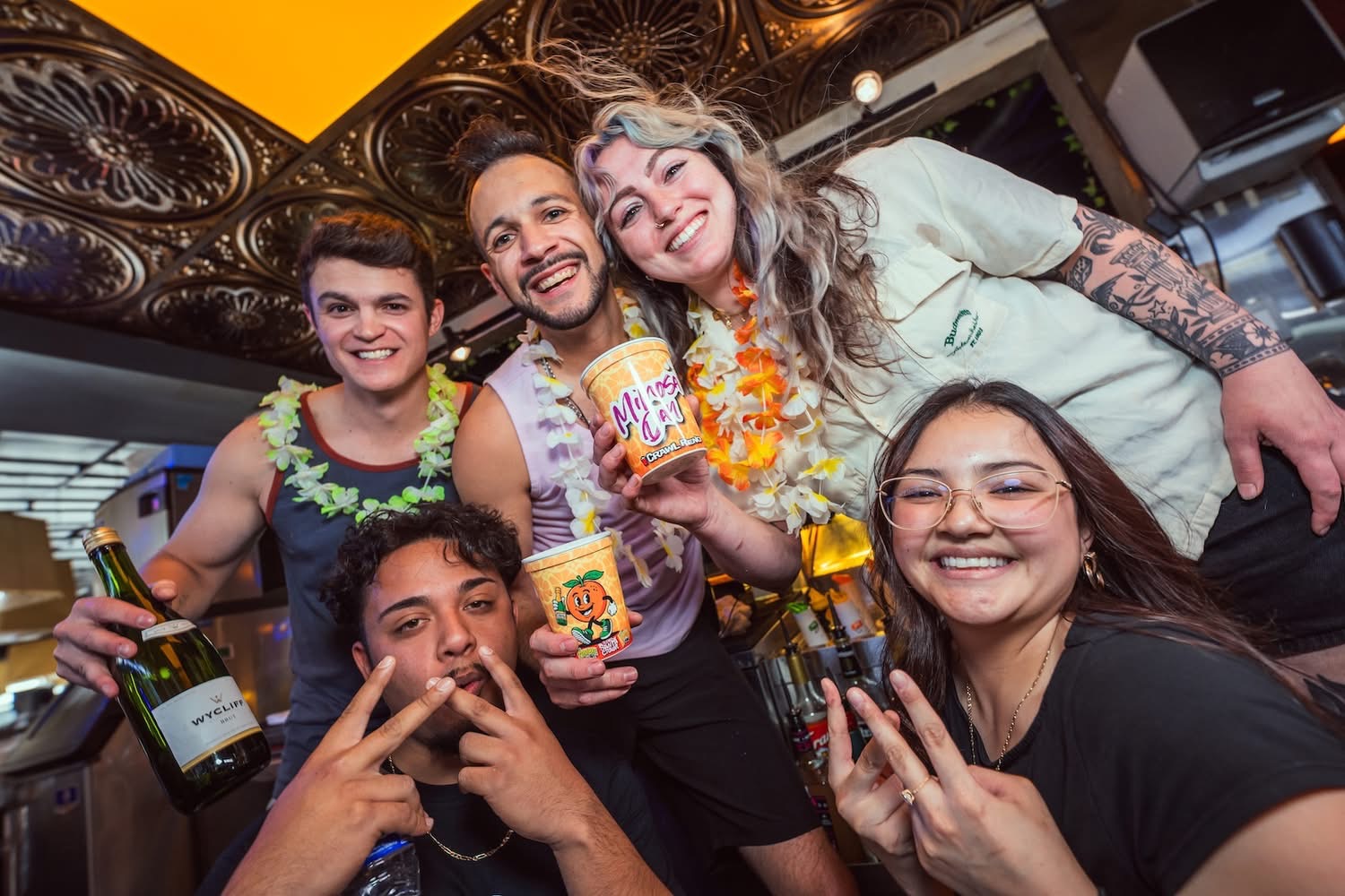 Group of friends at Hookava during the Mimosa Crawl holding Crawl Reno cups