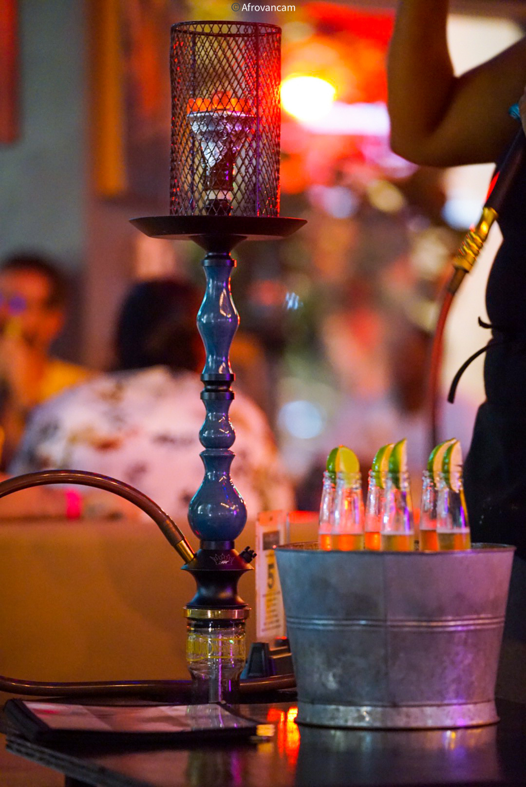 Blue hookah with hot plate and bucket of Corona bottles at Hookava bar