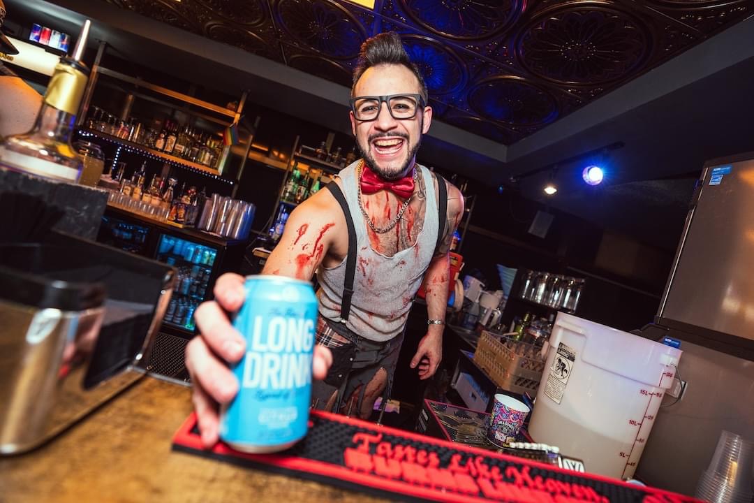Hookava bartender in zombie costume holding Long Drink can during Zombie Crawl