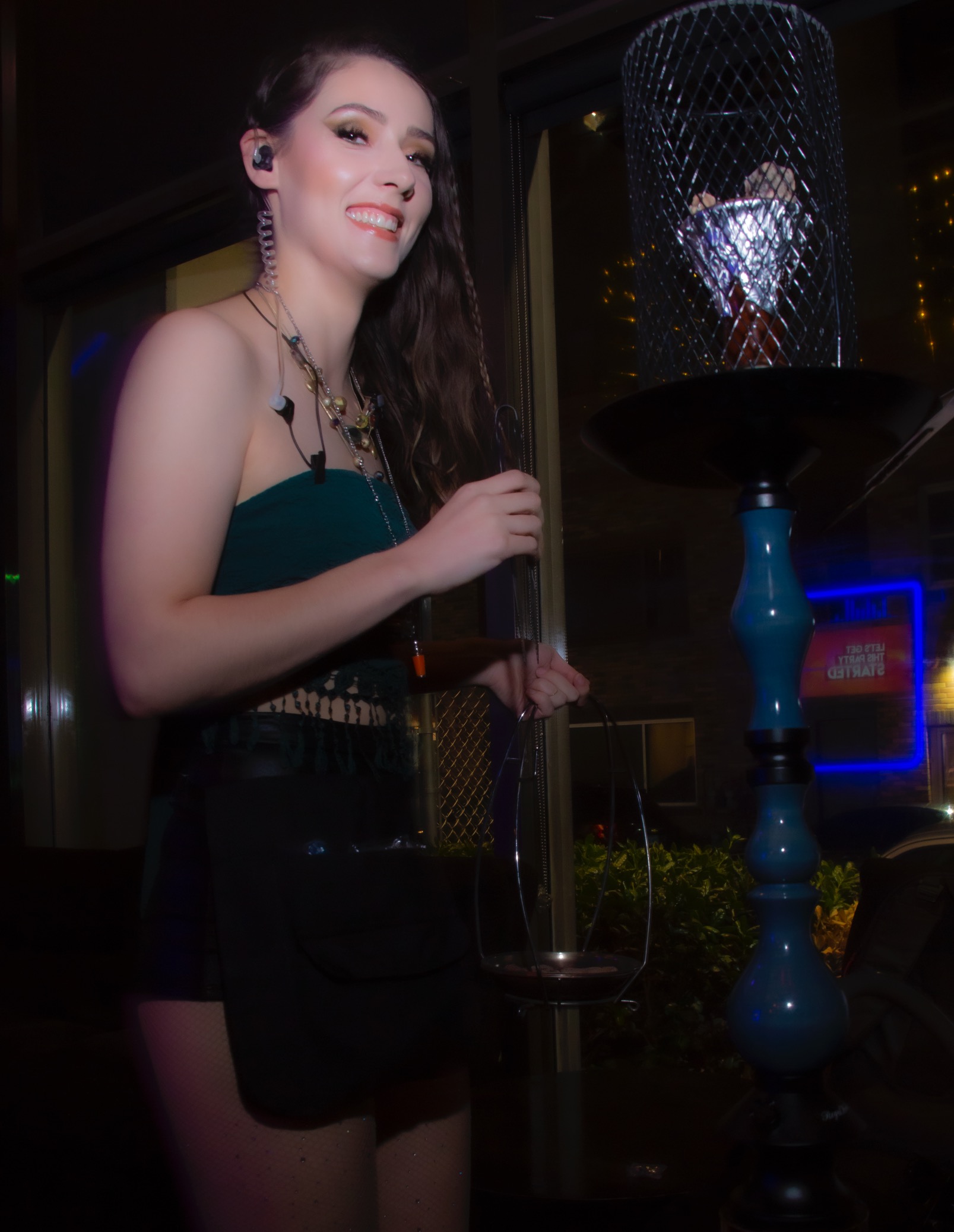 Guest posing with hookah at Hookava lounge during a Crawl Reno event